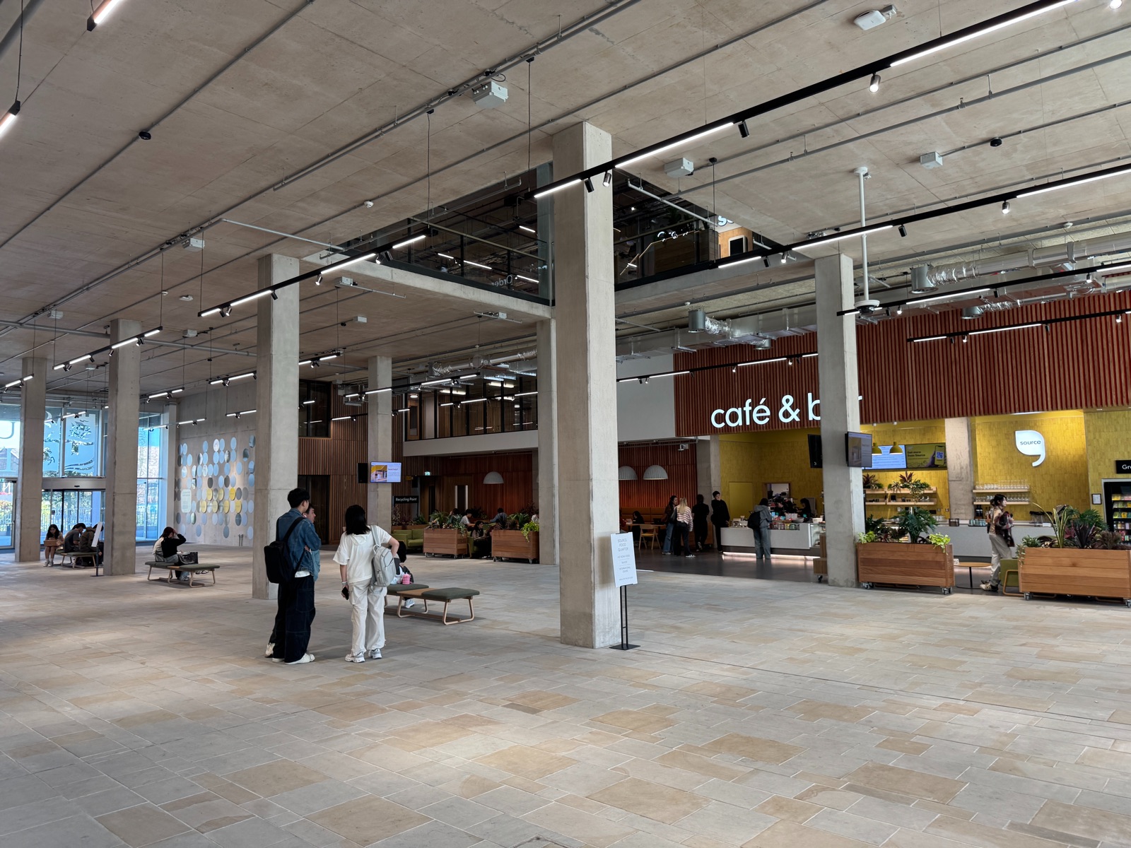 The entrance foyer of the Sloane Robinson Building, where attendees will be met, with seating and the café and bar beyond