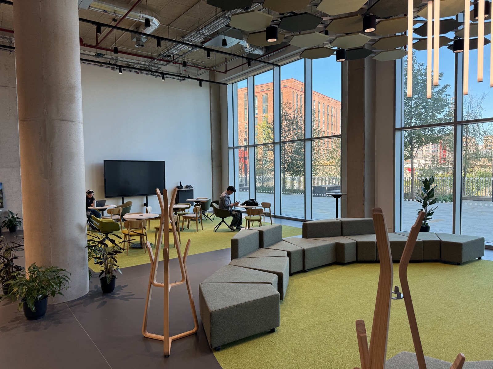 The Terrace Studio, a bright space with soft seating, tables and floor-to-ceiling windows looking out onto the outdoor terrace